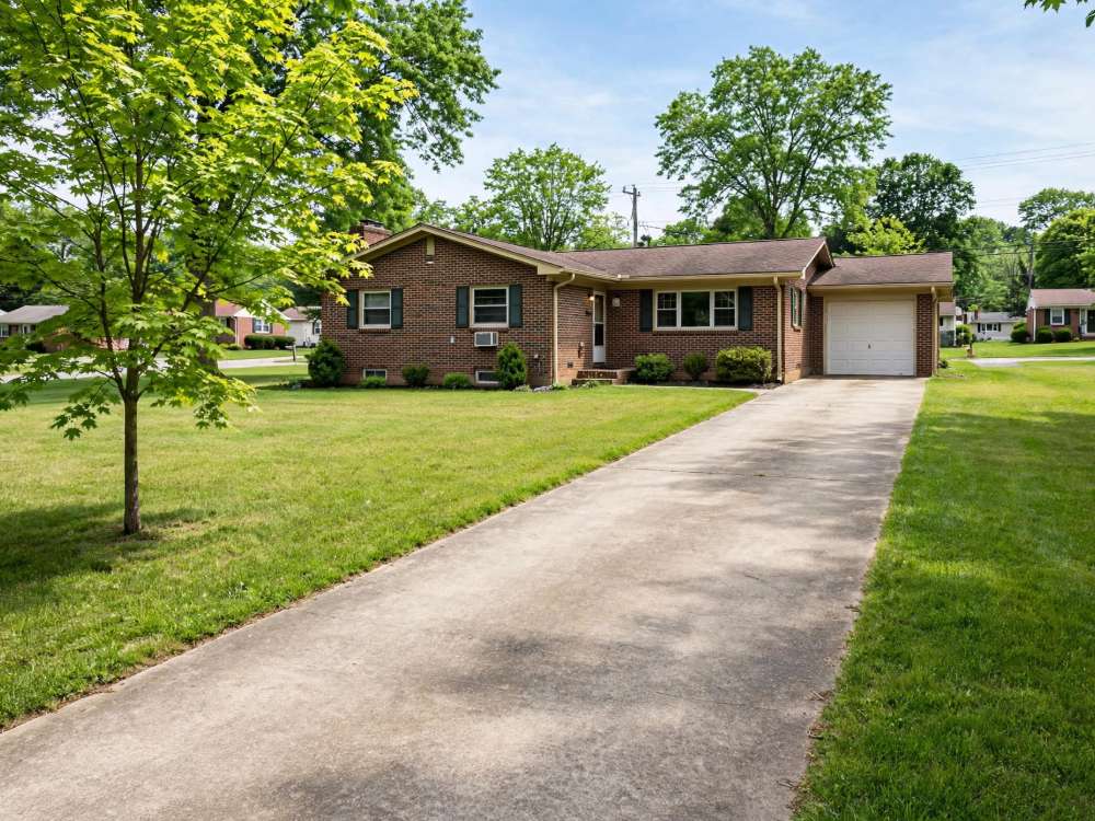 Ranch home on a wide lawn in an Ephrata Township subdivision, with a long front setback